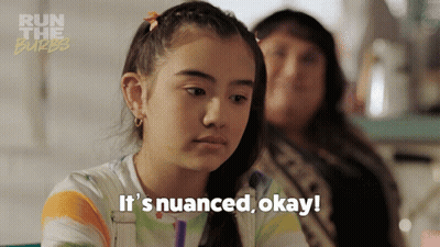 A Girl Says It 'S Nuanced Okay In Front Of A Run The Burbe Logo GIF