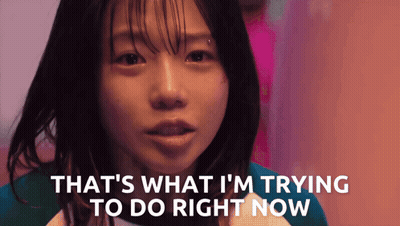 A Girl Says " That 'S What I 'M Trying To Do Right Now " In Front Of A Pink Background GIF