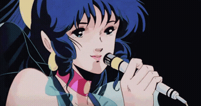 A Girl Singing Into A Microphone With Blue Hair GIF