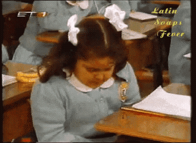 A Girl Sits At A Desk In A Classroom With Latin Soaps Fever Written On The Bottom Right GIF