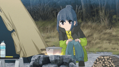 A Girl Sits In Front Of A Campfire With A Bottle Of Water In The Foreground GIF
