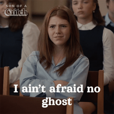 A Girl Sitting In A Classroom With The Words I Ain 'T Afraid No Ghost GIF