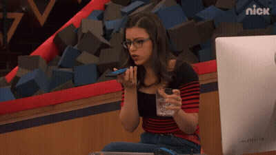 A Girl Sitting In Front Of A Computer With The Nick Logo On The Bottom Right GIF