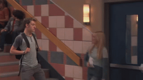 A Girl Standing In Front Of A Row Of Blue Lockers With Her Mouth Open GIF