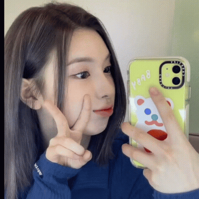 A Girl Taking A Picture Of Herself With A Case That Says Y908 GIF