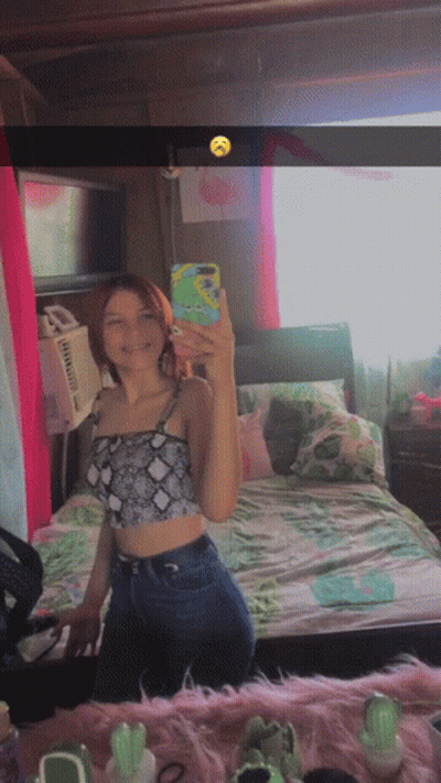 A Girl Taking A Selfie In Front Of A Mirror GIF