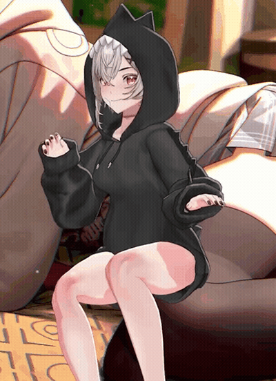A Girl Wearing A Black Cat Hoodie Sits On A Rug With The Letter S On It GIF