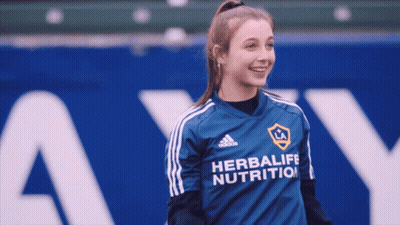 A Girl Wearing A Blue Adidas Herbalife Nutrition Shirt GIF