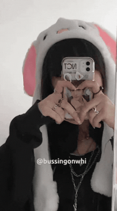 A Girl Wearing A Bunny Hat Takes A Picture Of Herself In A Mirror GIF
