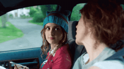 A Girl Wearing A Cat Hat Is Sitting In The Back Seat Of A Car With Another Girl GIF