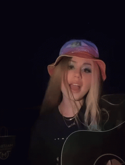 A Girl Wearing A Hat That Says Cowboys On It GIF