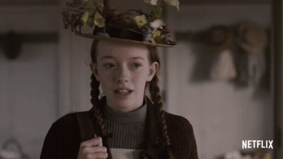 A Girl Wearing A Hat With Flowers On It And The Word Netflix On The Bottom GIF