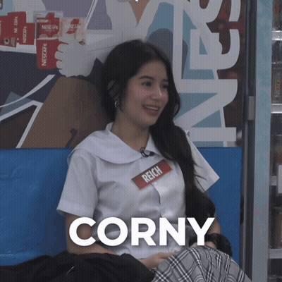 A Girl Wearing A Name Tag That Says Corny GIF