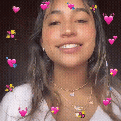 A Girl Wearing A Necklace That Says " Angel " GIF
