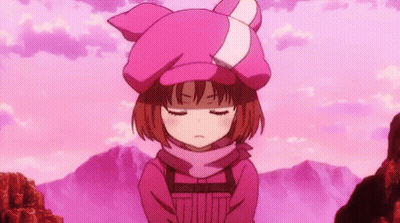 A Girl Wearing A Pink Hat And Scarf Is Standing In Front Of A Mountain With Her Eyes Closed . GIF