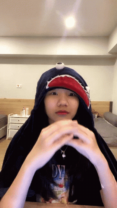 A Girl Wearing A Shark Hoodie And A Dye Shirt GIF