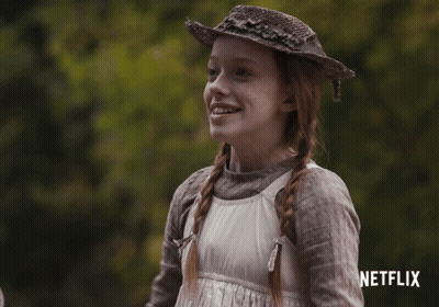 A Girl Wearing A Straw Hat And A White Dress With A Netflix Logo In The Corner GIF