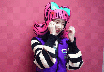 A Girl Wearing A Striped Jacket And A Pink Hat With A Bow GIF
