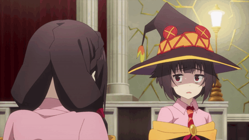 A Girl Wearing A Witch Hat Is Looking At Another Girl GIF