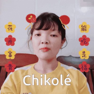 A Girl Wearing A Yellow Shirt With Chikole Written On It GIF