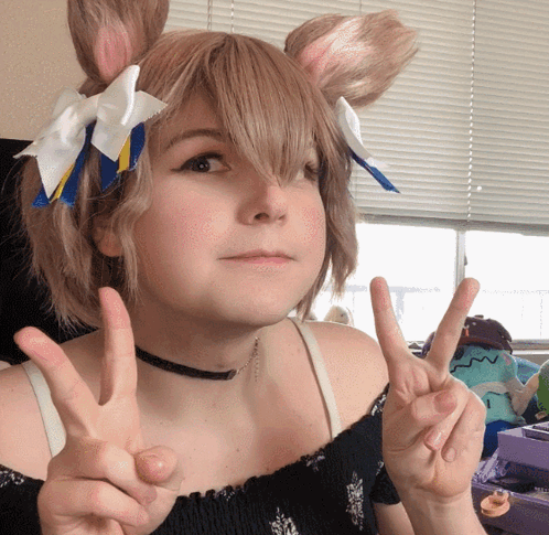 A Girl Wearing Bunny Ears And A Choker Giving The Peace Sign GIF