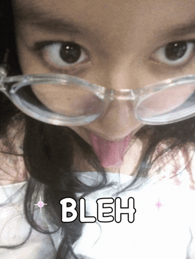 A Girl Wearing Glasses Is Sticking Her Tongue Out And The Word Bleh Is On The Bottom Right GIF