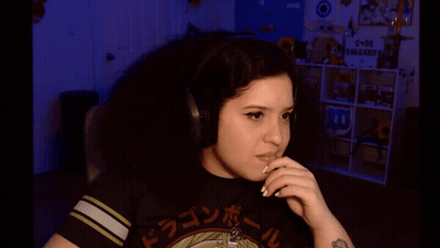 A Girl Wearing Headphones And A Dragon Ball Shirt GIF