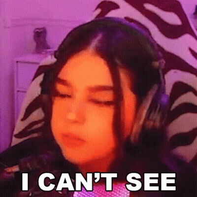 A Girl Wearing Headphones Is Making A Funny Face And Saying `` I Can T See '' . GIF