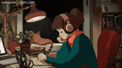 A Girl Wearing Headphones Is Sitting At A Desk With A Laptop GIF