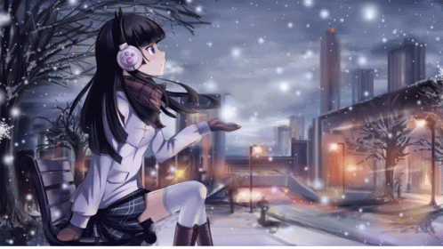 A Girl Wearing Headphones Sits In The Snow GIF