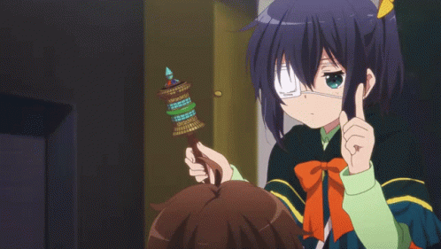 A Girl With A Bandage On Her Eye Is Pointing At Another Girl GIF