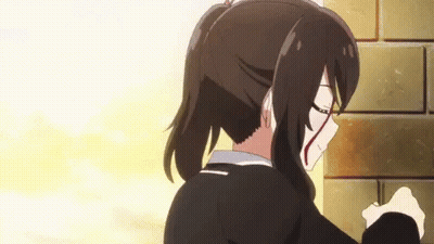 A Girl With A Bloody Face Is Standing Next To A Brick Wall GIF