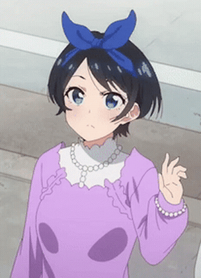 A Girl With A Blue Bow On Her Head Is Wearing A Purple Shirt And Pearls GIF