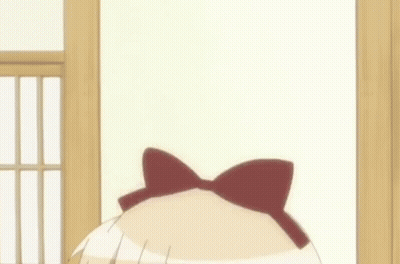 A Girl With A Bow On Her Head Is Making A Funny Face GIF