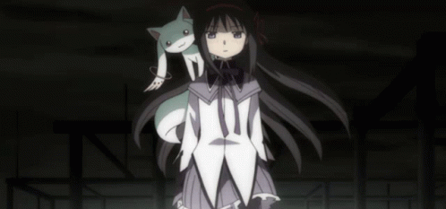 A Girl With A Cat On Her Shoulder Is Standing In The Dark GIF