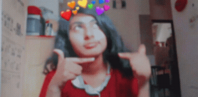 A Girl With A Crown Of Hearts On Her Head Is Making A Funny Face GIF