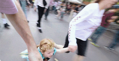 A Girl With A Crown On Her Head Is Being Held By A Woman GIF