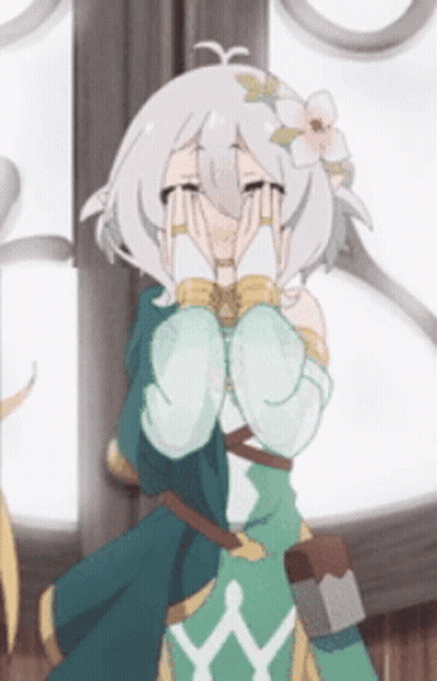 A Girl With A Flower In Her Hair Is Covering Her Face With Her Hands . GIF