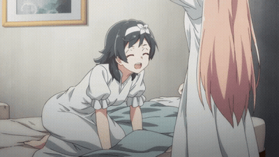 A Girl With A Flower On Her Head Is Kneeling On A Bed Next To Another Girl GIF