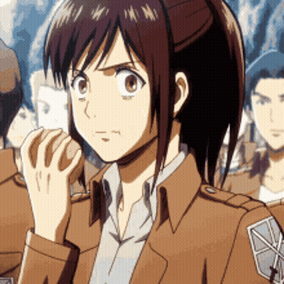 A Girl With A Ponytail Is Wearing A Brown Jacket And A White Shirt GIF