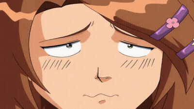 A Girl With A Purple Flower In Her Hair Makes A Funny Face GIF