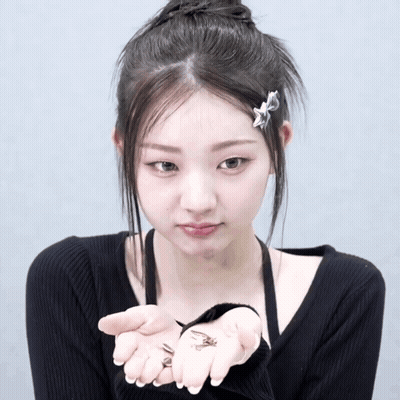 A Girl With A Star In Her Hair Is Holding A Small Bug GIF