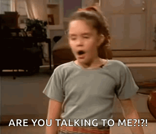 A Girl With A Surprised Look On Her Face Says Are You Talking To Me ? GIF