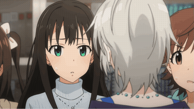 A Girl With A Turtleneck And A Necklace Looks At Another Girl GIF