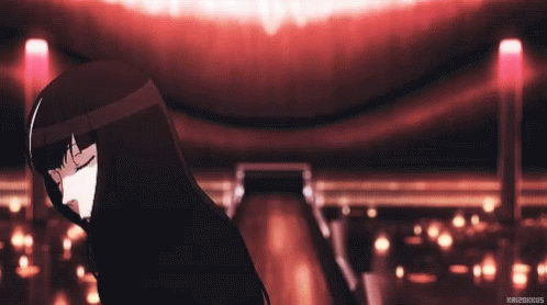 A Girl With Black Hair Is Dancing In A Dark Room With Her Eyes Closed . GIF