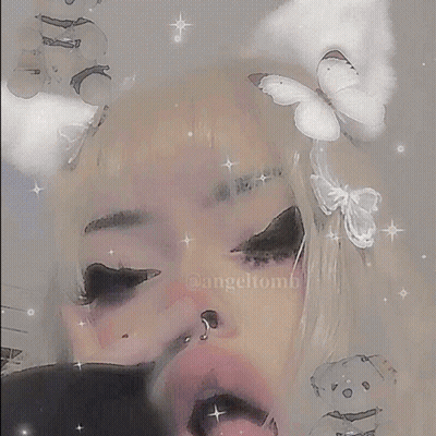 A Girl With Black Hair Is Taking A Selfie With Her Hand On Her Face . GIF