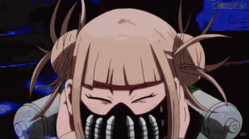 A Girl With Blonde Hair And A Mask On Her Face Looks At The Camera With Her Eyes Closed GIF