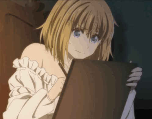 A Girl With Blonde Hair And Blue Eyes Is Looking At A Piece Of Paper GIF