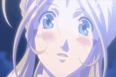 A Girl With Blonde Hair And Blue Eyes Looks At The Camera GIF