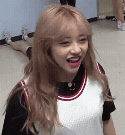 A Girl With Blonde Hair And Pink Lips Is Laying On The Floor . GIF